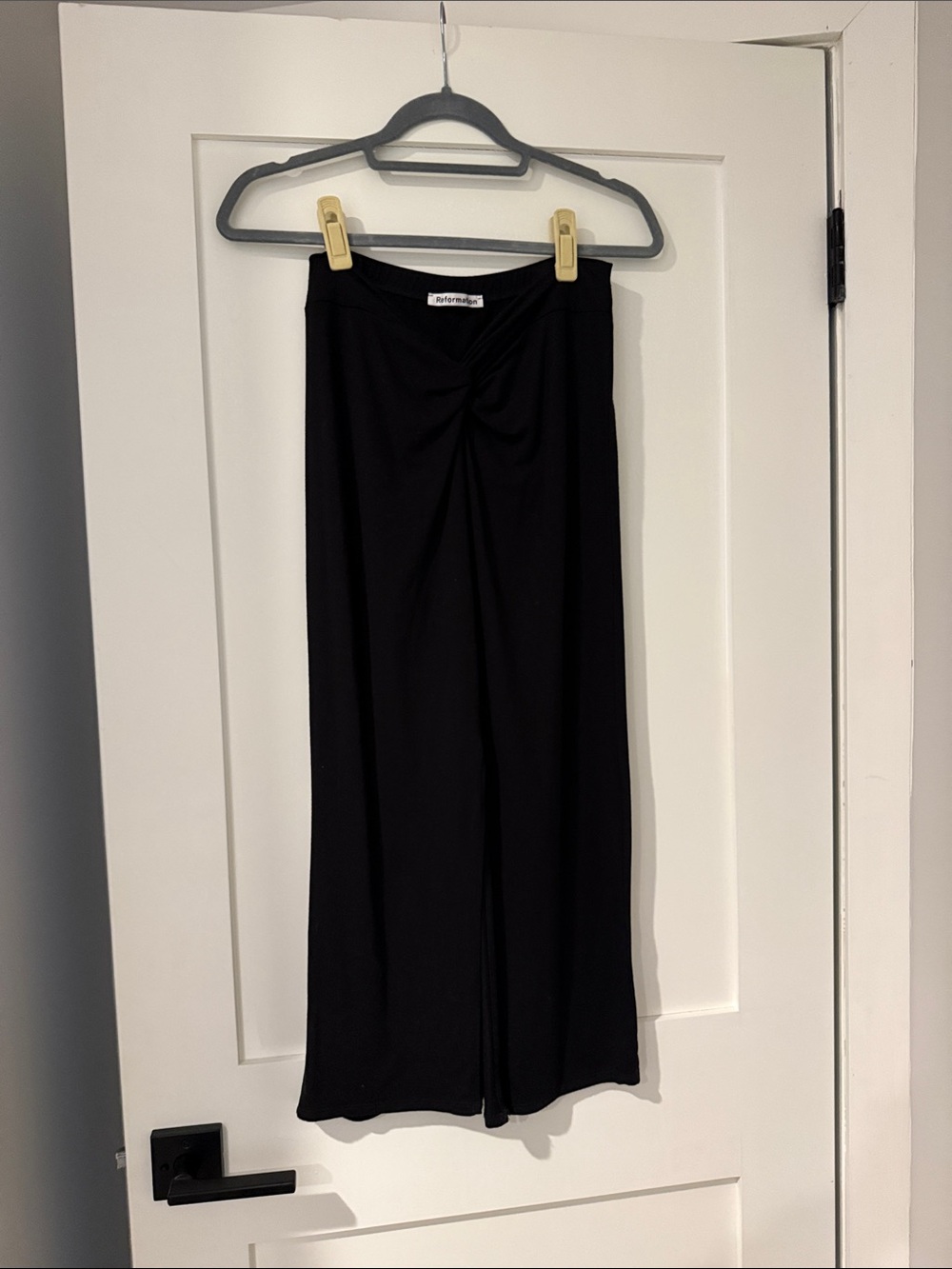 Reformation black midi twist front knit skirt